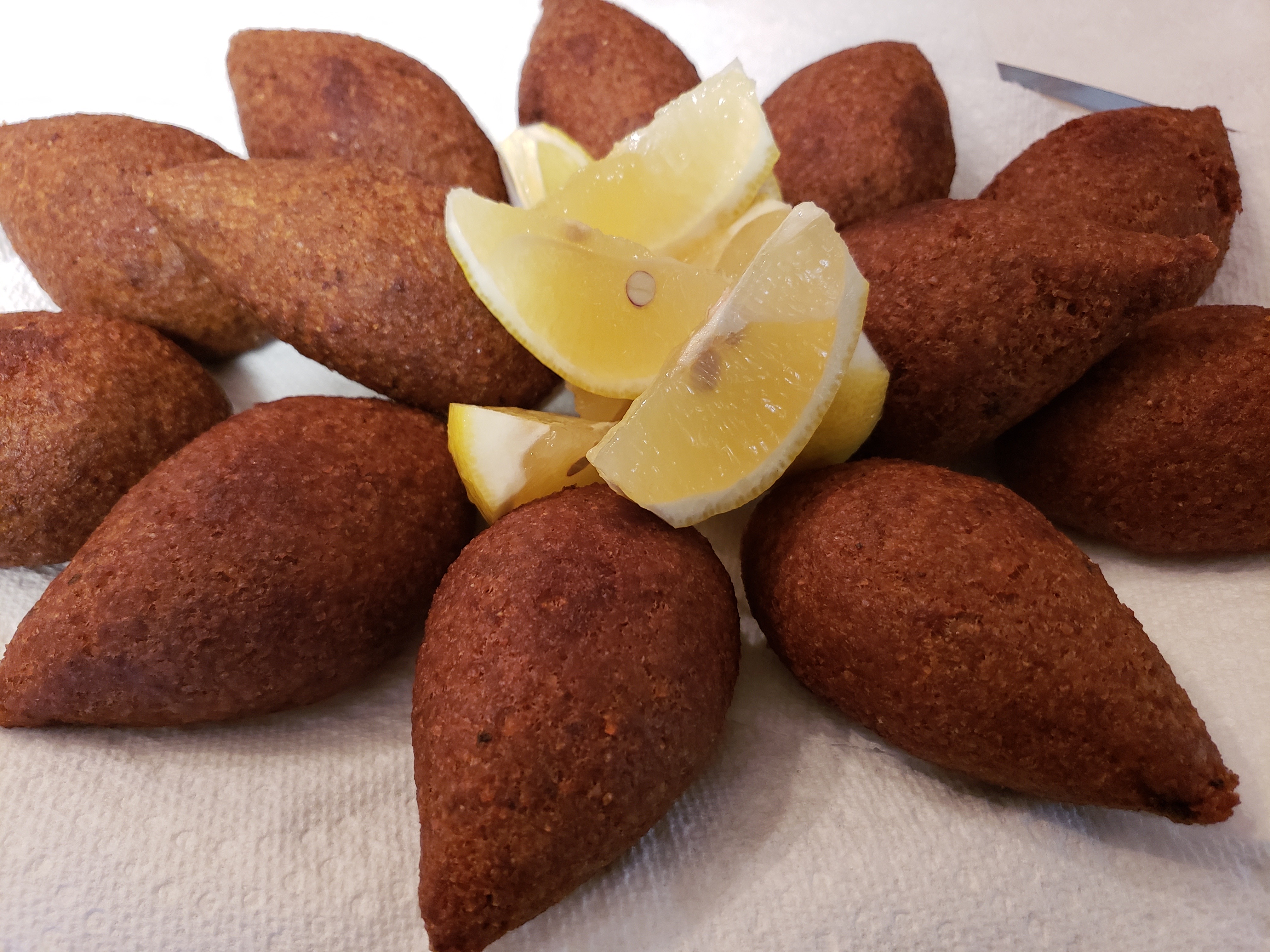 Kibbi (Ground Wheat balls filled with beef, pine nuts & Spices)