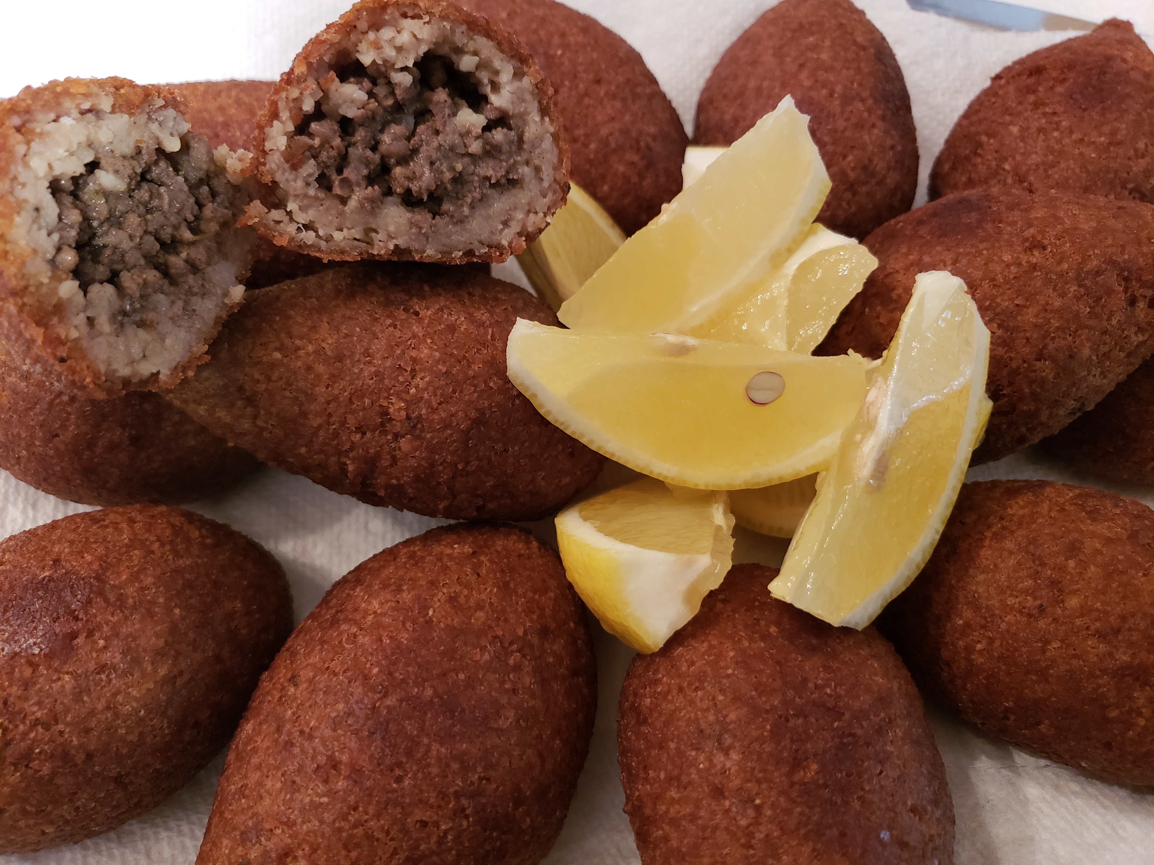 Kibbi (Ground Wheat balls filled with beef, pine nuts & Spices)