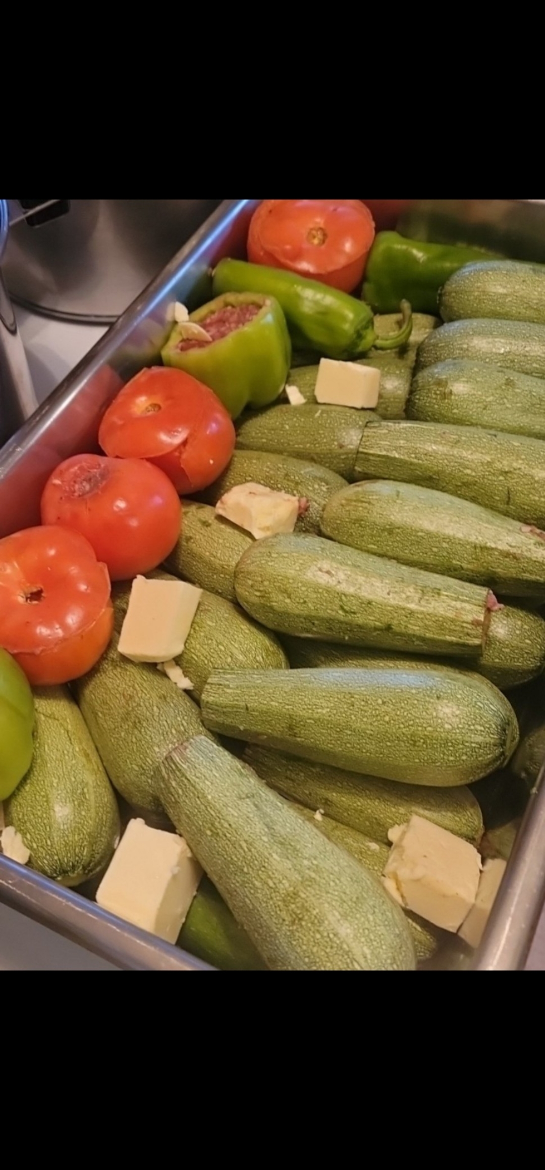 Stuffed Zucchini and Tomato Baked in our Famous Seasoned Tomato Sauce