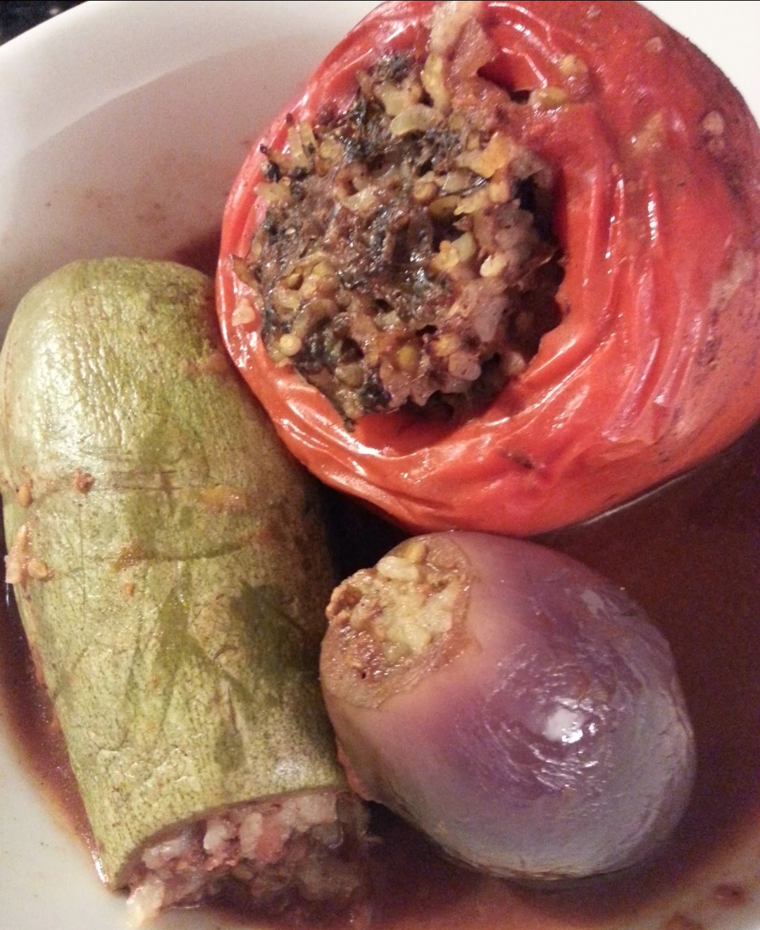 Stuffed Zucchini and Tomato Baked in our Famous Seasoned Tomato Sauce